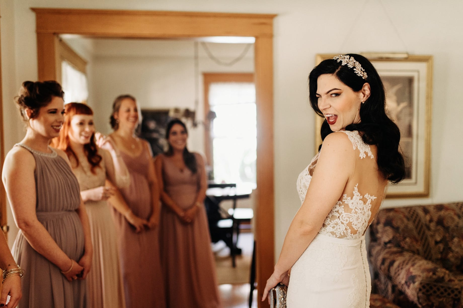 bride revealing herself to her bridesmaids