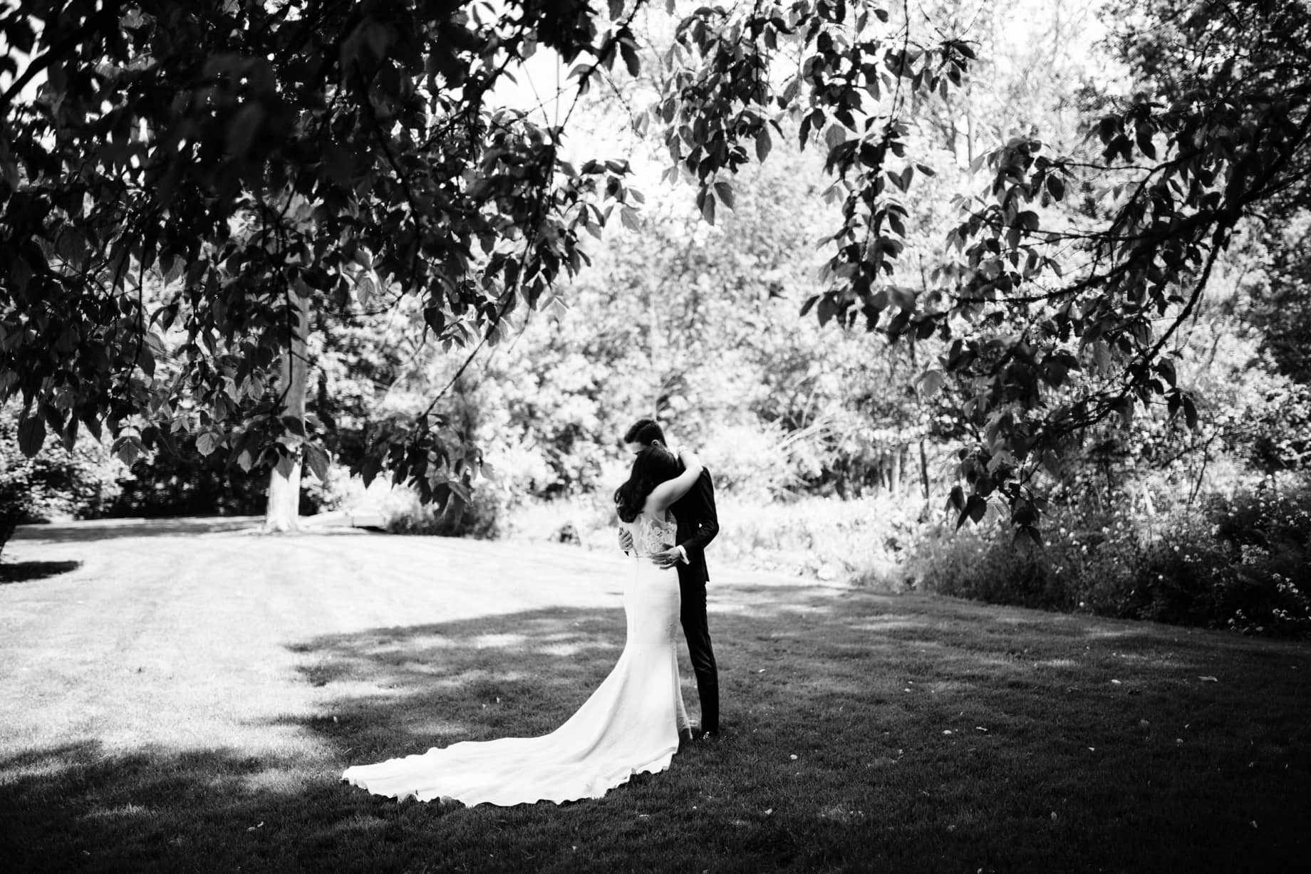 black and white portrait of a bride and groom embracing