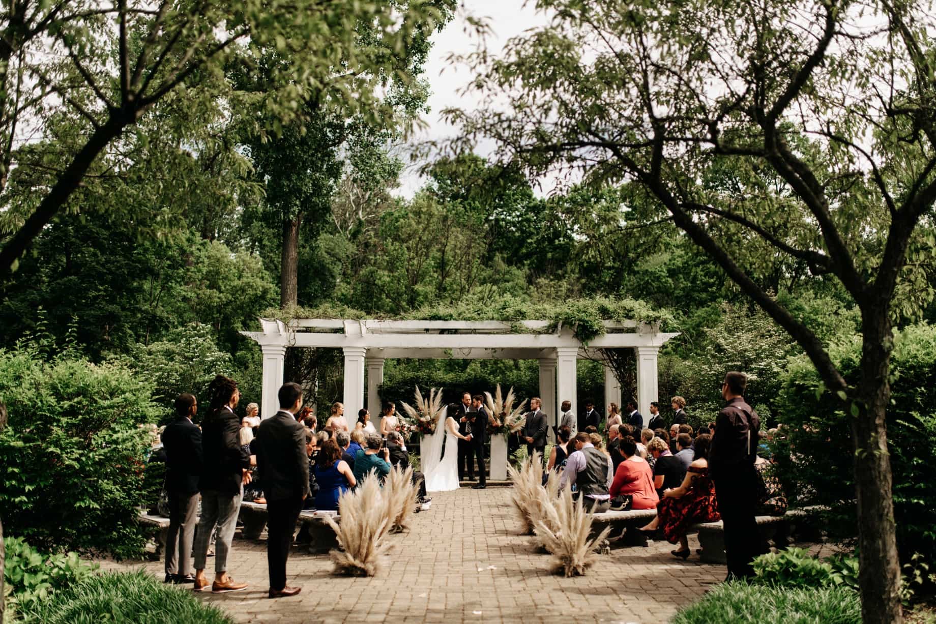 wedding ceremony under the pergola at wellers in saline michigan