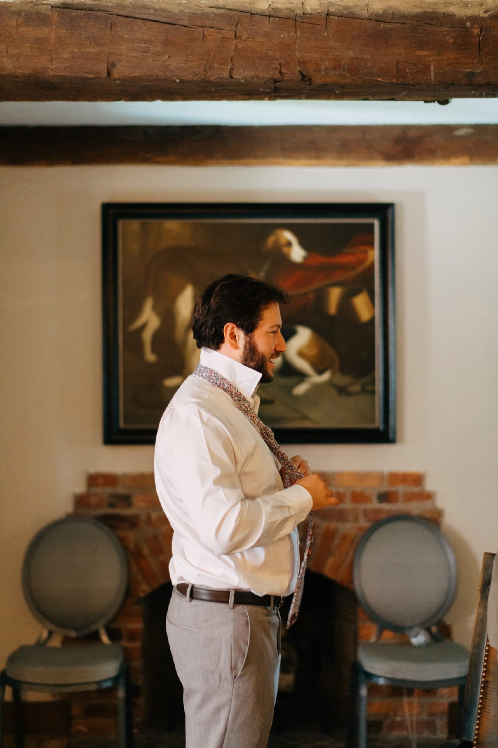 groom putting on his tie