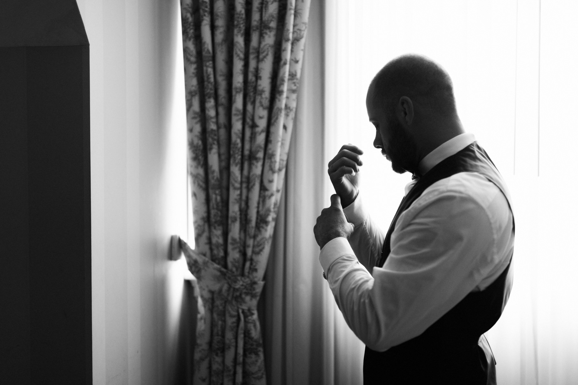 groom adjusting his cufflinks