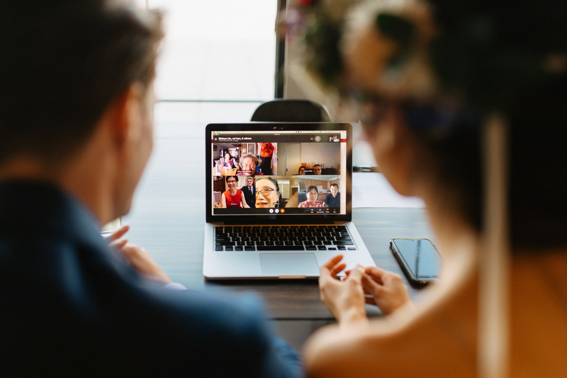 a couple has a zoom meeting with friends and family after their covid elopement