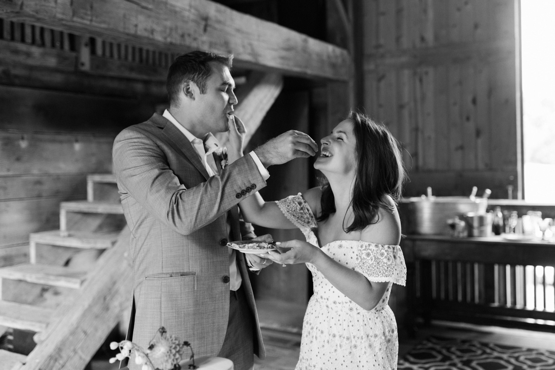 couple feeds one another wedding cake