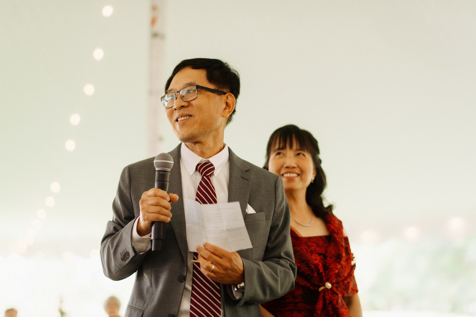 parents of the bride share a toast during the wedding reception