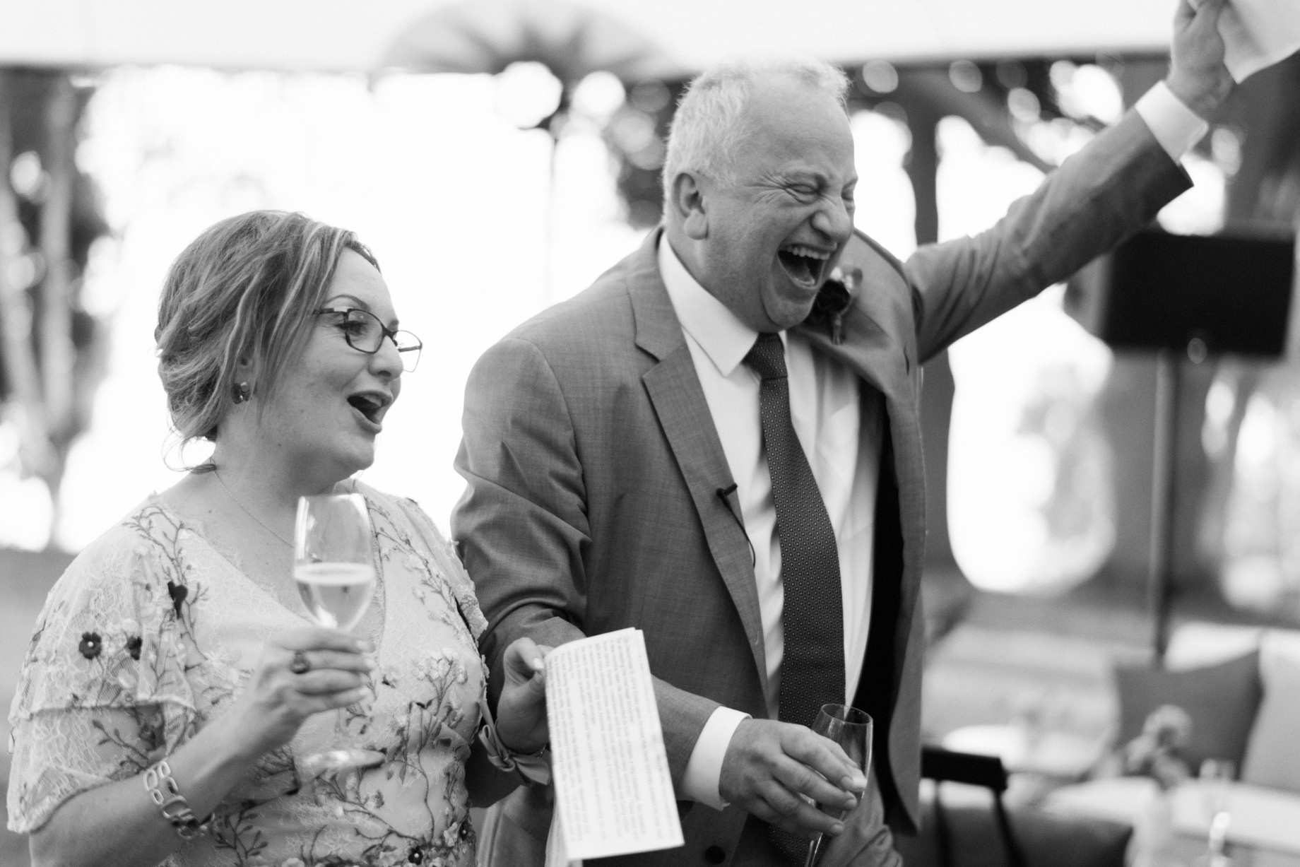 parents of the groom enthusiastically toast their son