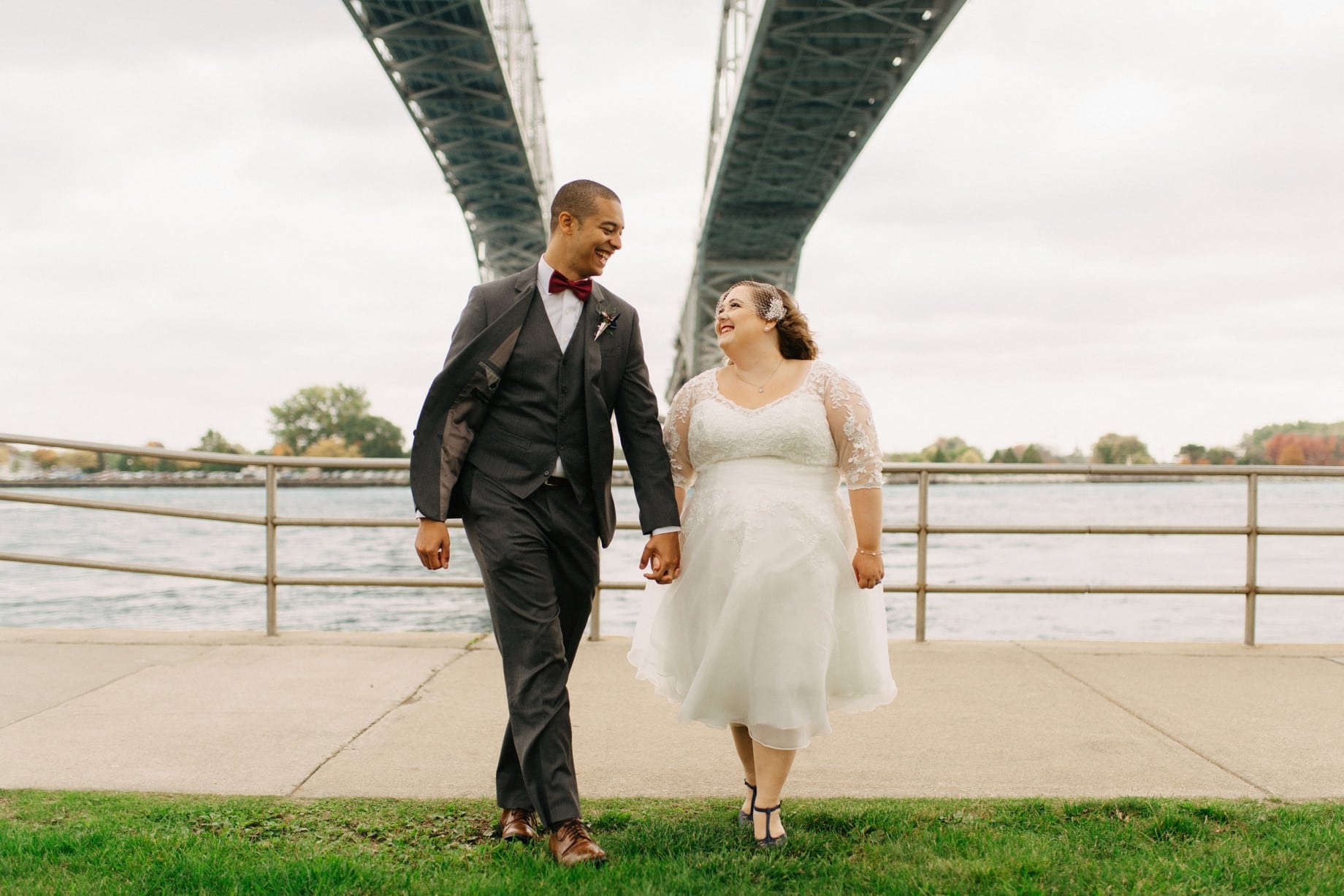 a couple strolling under the blue water bridge in port huron michigan