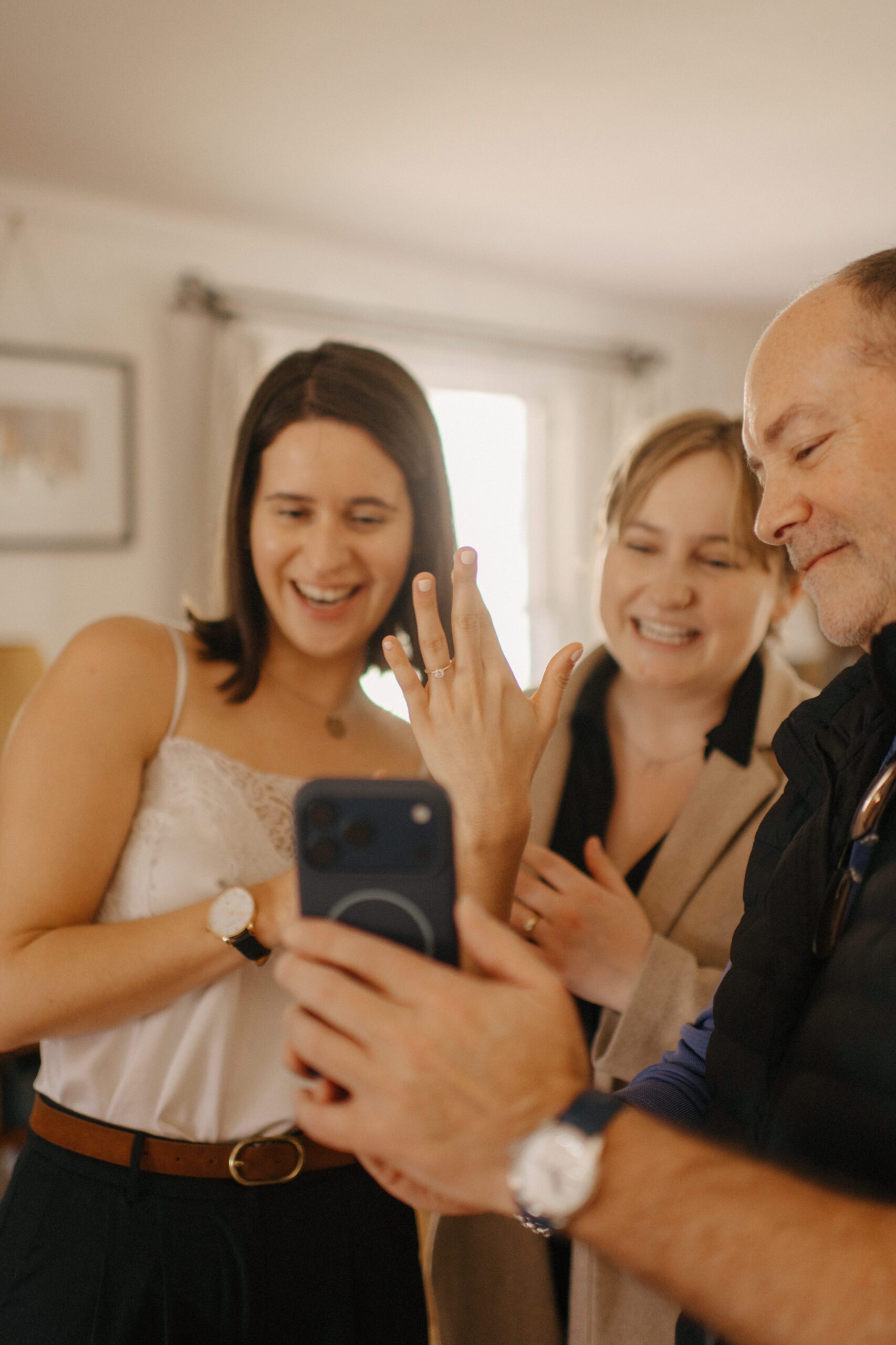 A couple celebrates with their family right after getting engaged.