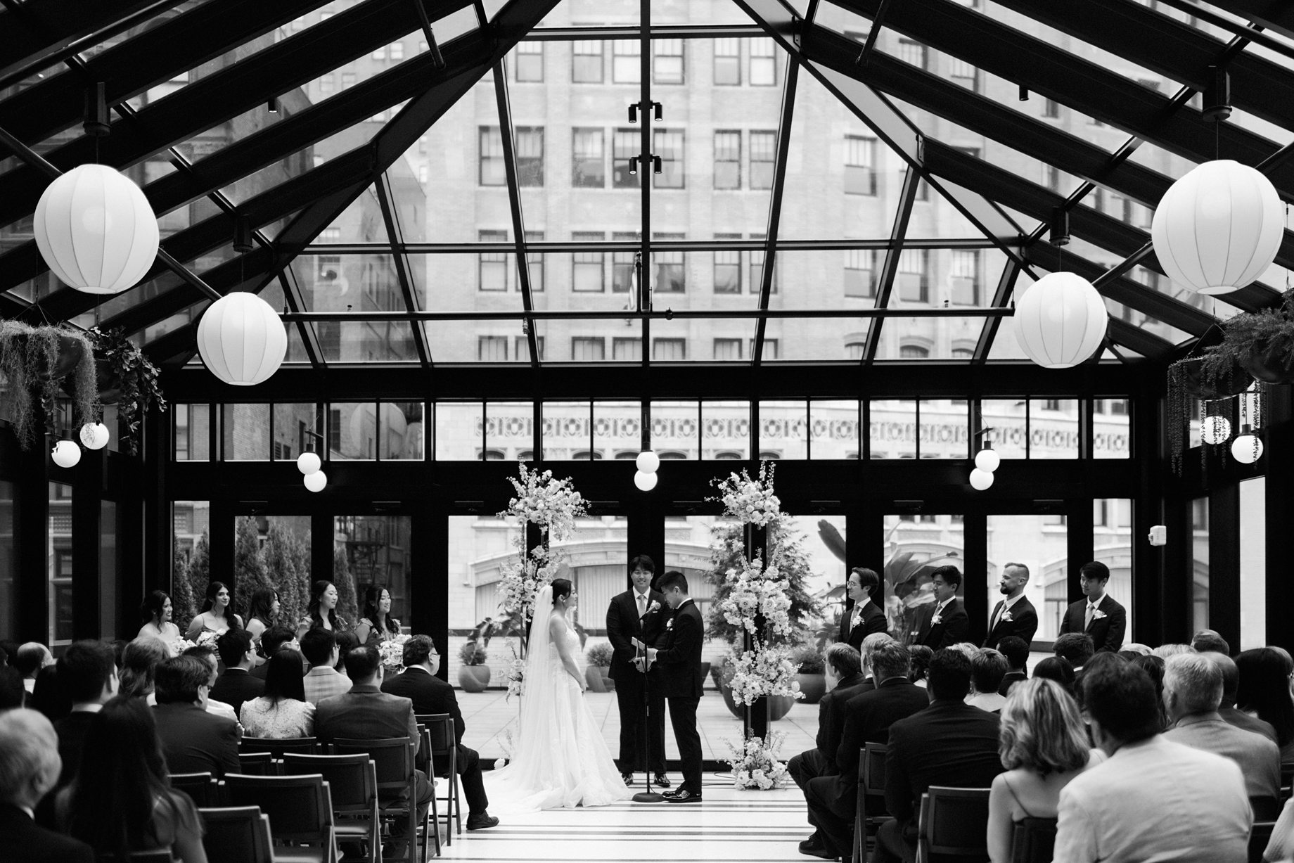 black and white photograph of a wedding ceremony in the birdy room