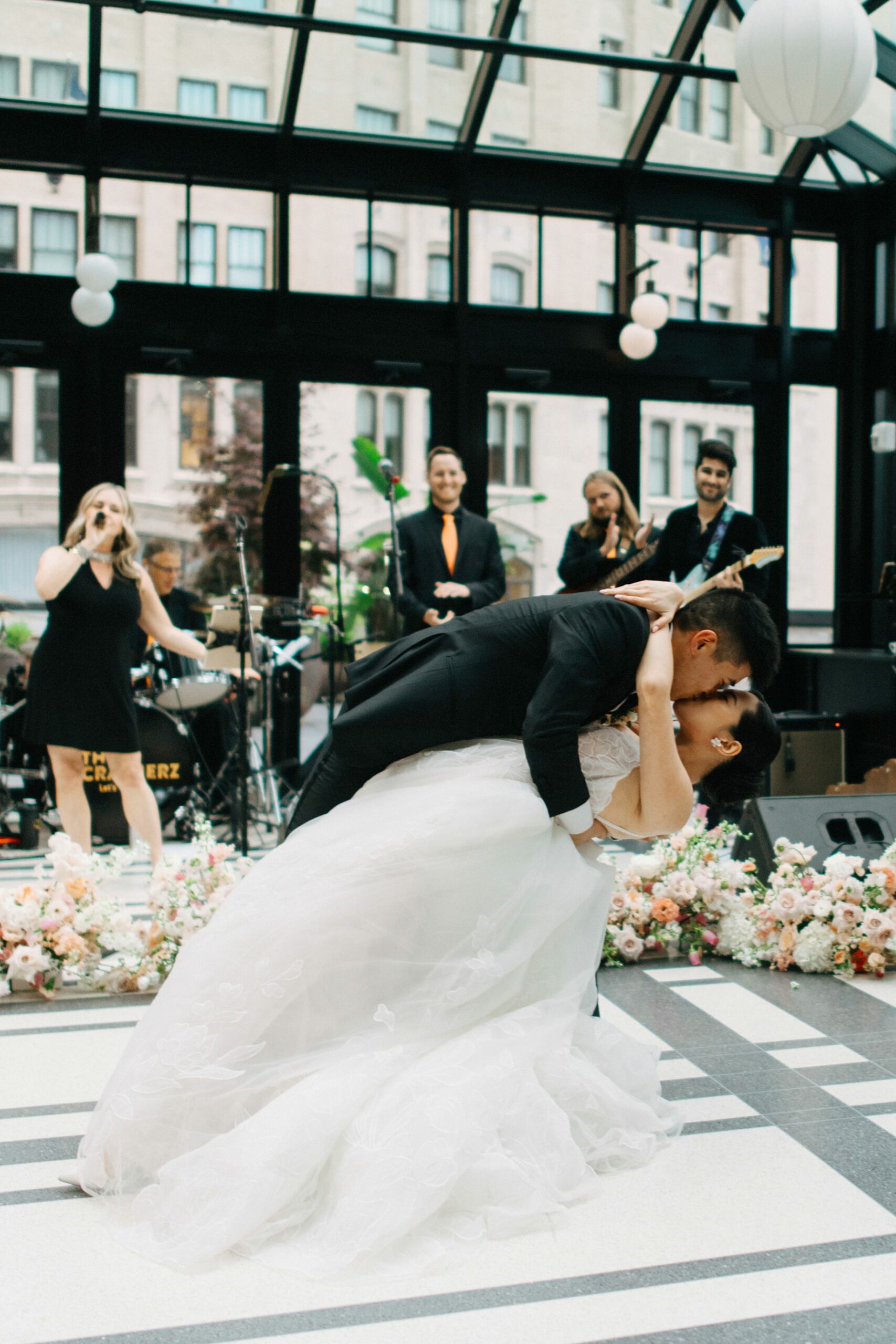 Groom dips the bride in a romantic flourish during their first dance