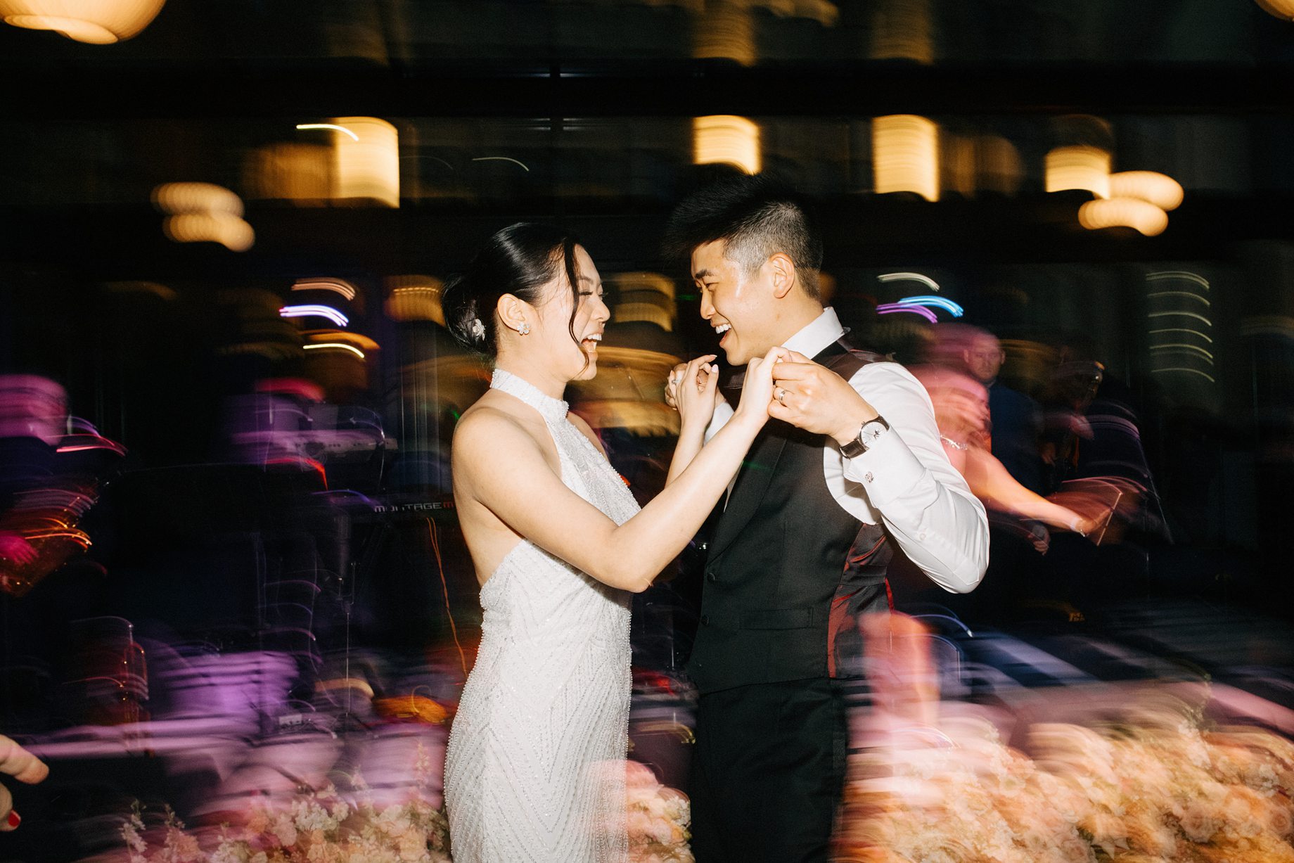 candid photo of bride and groom dancing with motion blur