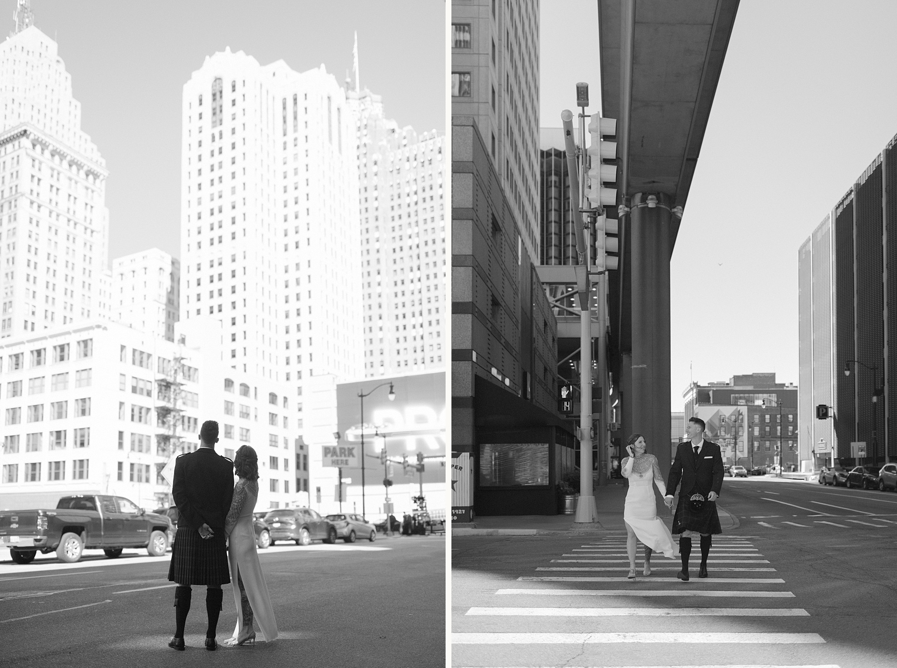 Bride and groom stand in the middle of a downtown Detroit street with skyscrapers in the background in editorial wedding photography by Heather Jowett