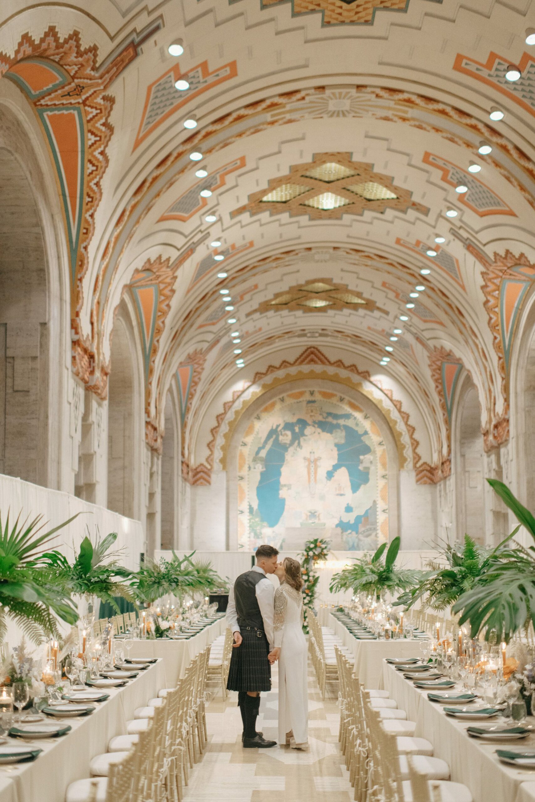 Bride and groom share a quiet moment in the candlelit reception space of the Guardian Building