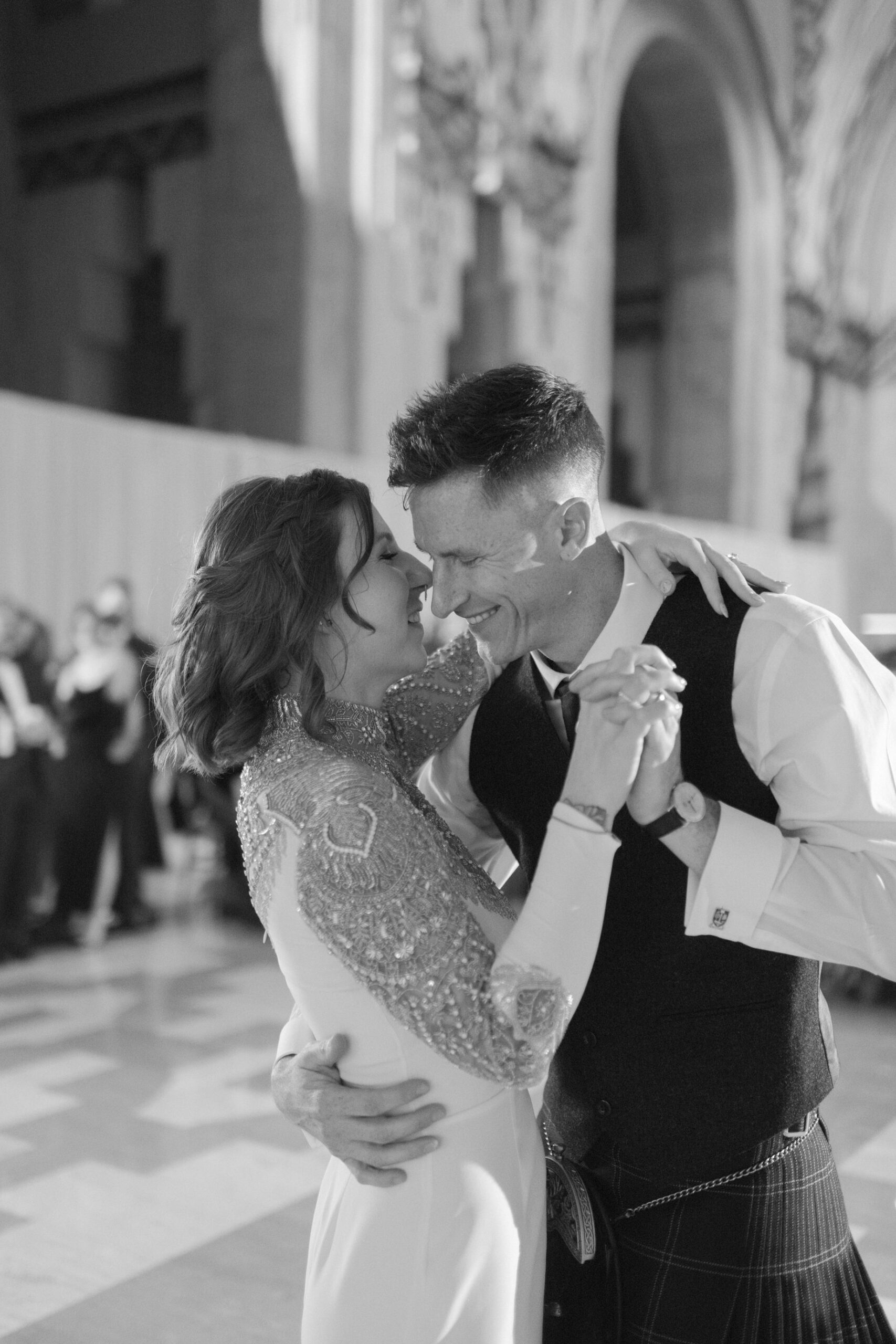 Black and white photograph of a bride and groom laughing during their first dance at their Guardian Building wedding