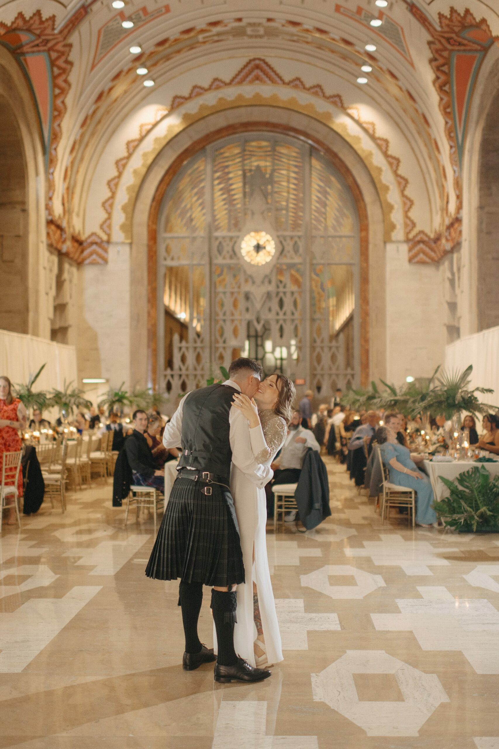 Bride and groom embracing during their first dance in the lobby of the guardian building