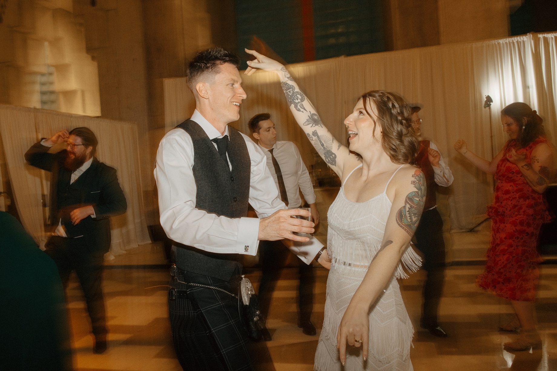 Candid photo of the bride and groom dancing the night away