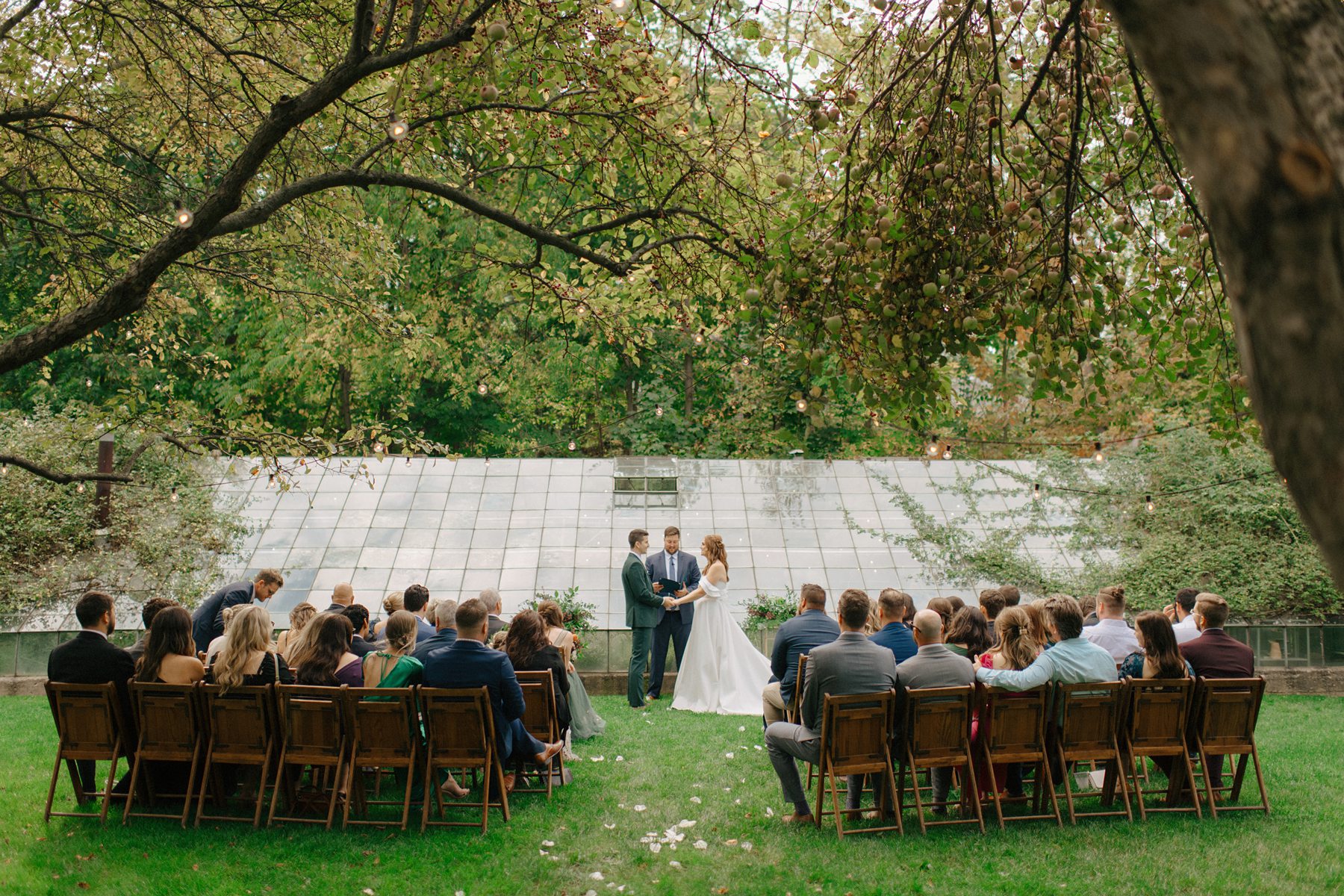 Wedding ceremony in front of the Glass House Community greenhouse