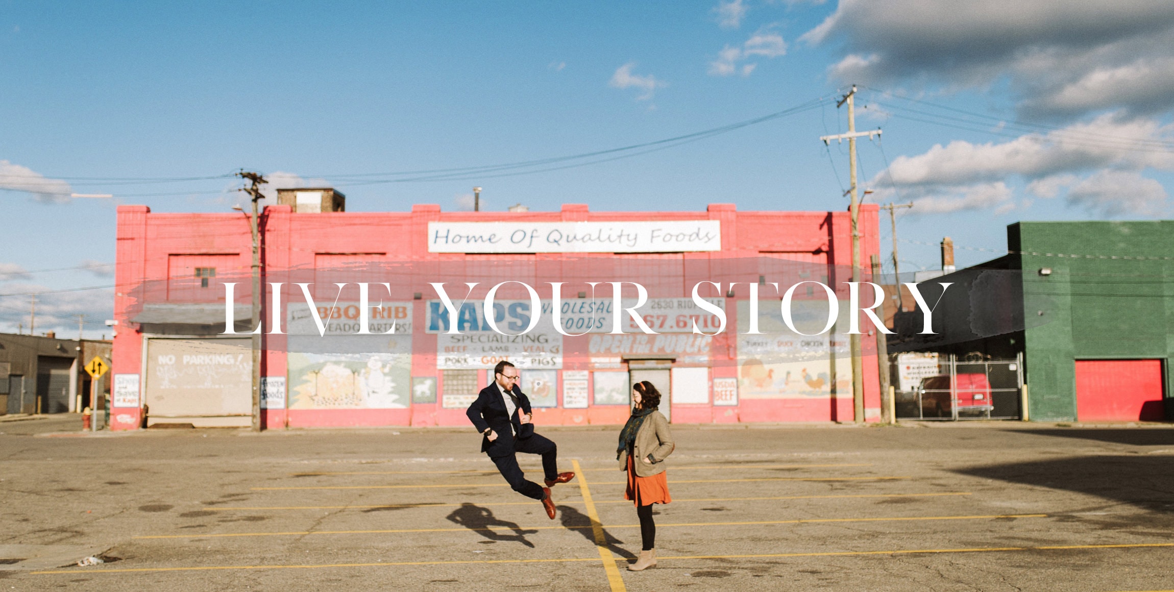 a fun couple poses for their engagement photography in eastern market detroit
