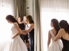 The mother of the bride helps the daughter get dressed before her Detroit Wedding