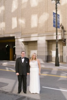 Bride and groom take portraits around downtown Detroit.
