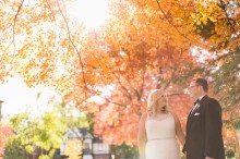 Bride and groom take portraits in Detroit's Indian Village Neighborhood amongst Michigan's fall foliage.