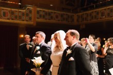 Bride is given away by her brothers at a wedding ceremony at the Gem Theater in Detroit