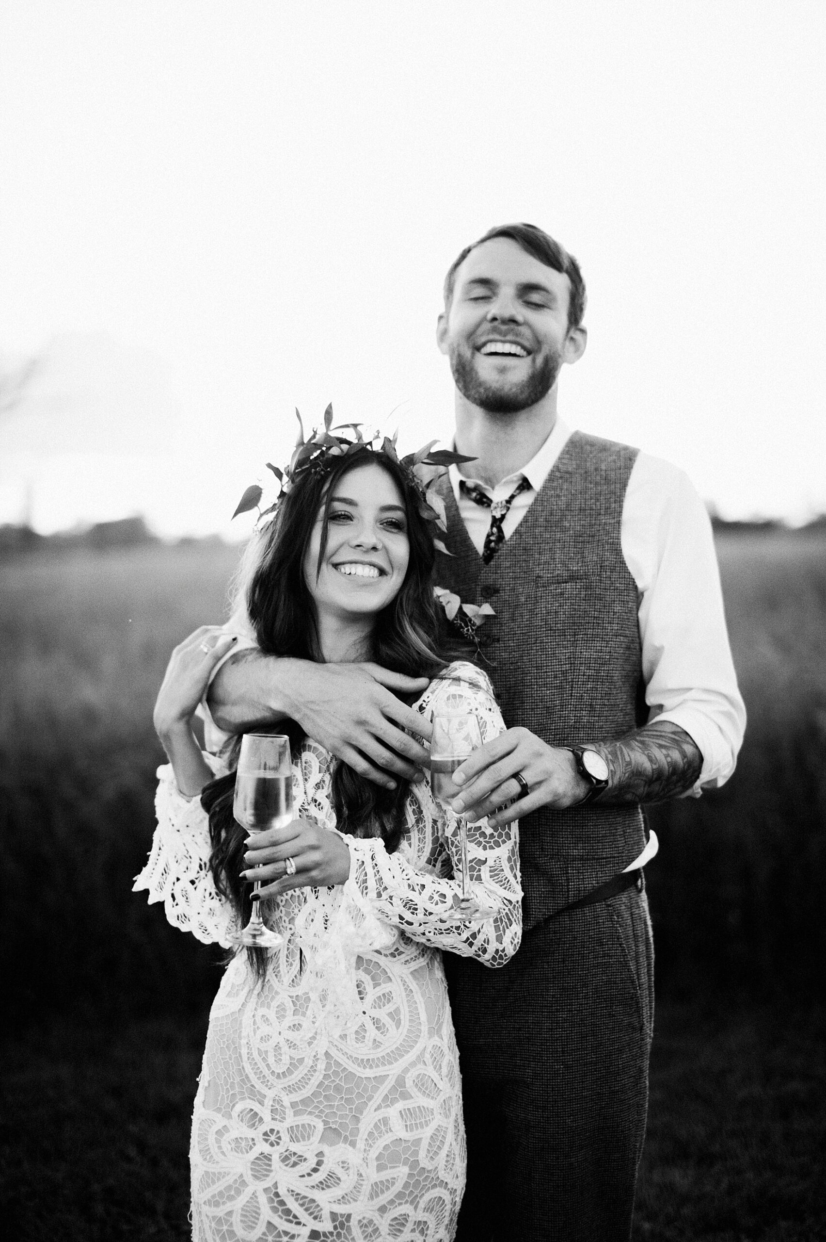 bride and groom posing with champagne