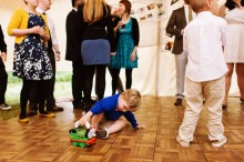 child playing with toy on wedding dance floor