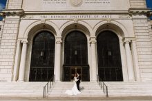 a portrait of a bride and groom at the woodward entrace of the detroit institute of arts