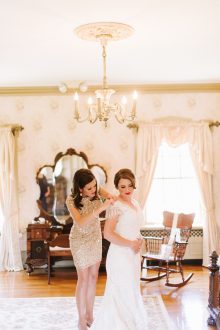 bride getting dressed in the bridal suite at the felt mansion
