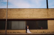 bride and groom pose for portrait in downtown pontiac