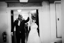 bride and groom entering ballroom at lafayette grande wearing mardi gras masks