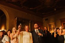 bride and groom raising a glass at their whitney mansion wedding