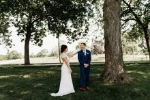 bride and groom sharing first look on the front lawn of zingermans cornman farms