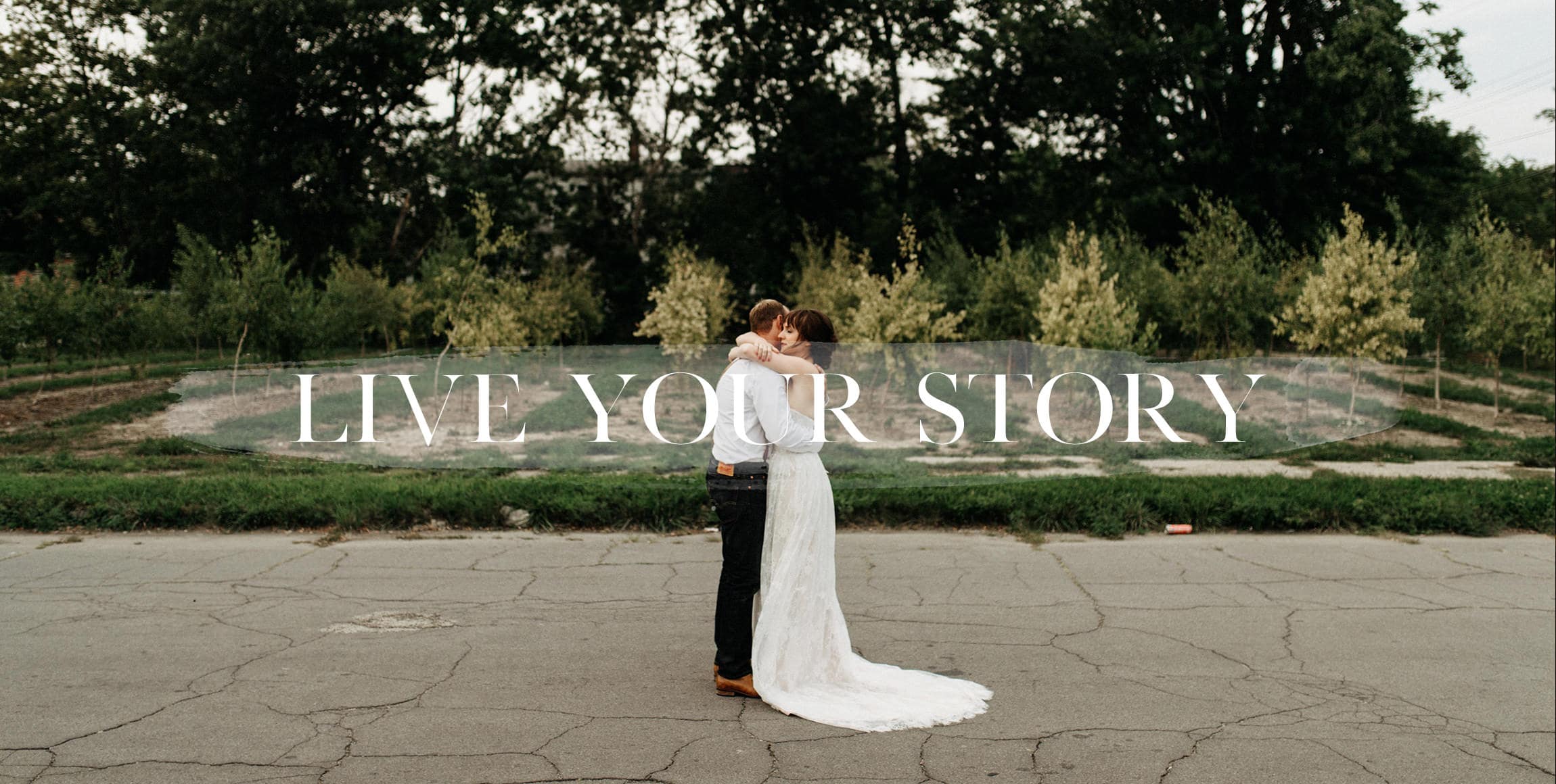 a couple embraces in the streets of detroit by wedding photographer Heather Jowett