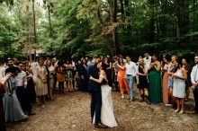 bride and groom surrounded by loved ones during their first dance