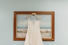 a wedding dress hanging on a frame by Detroit wedding photographer Heather Jowett
