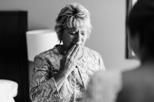 mother of the bride holds back tears seeing her daughter in her dress