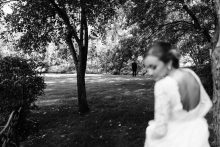 a photo of a bride walking to her first look by documentary Detroit wedding photographer Heather Jowett