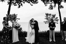 couple share a first kiss during their Lakefront wedding in Michigan