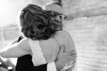 father of the bride hugging his daughter