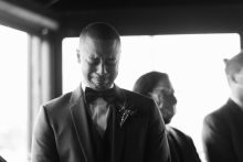 groom having an emotional reaction to seeing his bride coming down the aisle