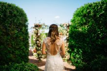 a bride in the rose garden at the perry hotel in petoskey