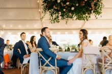 a bride and groom share an intimate moment during toasts
