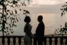 bride and groom silhouetted against lake huron in lexington michigan