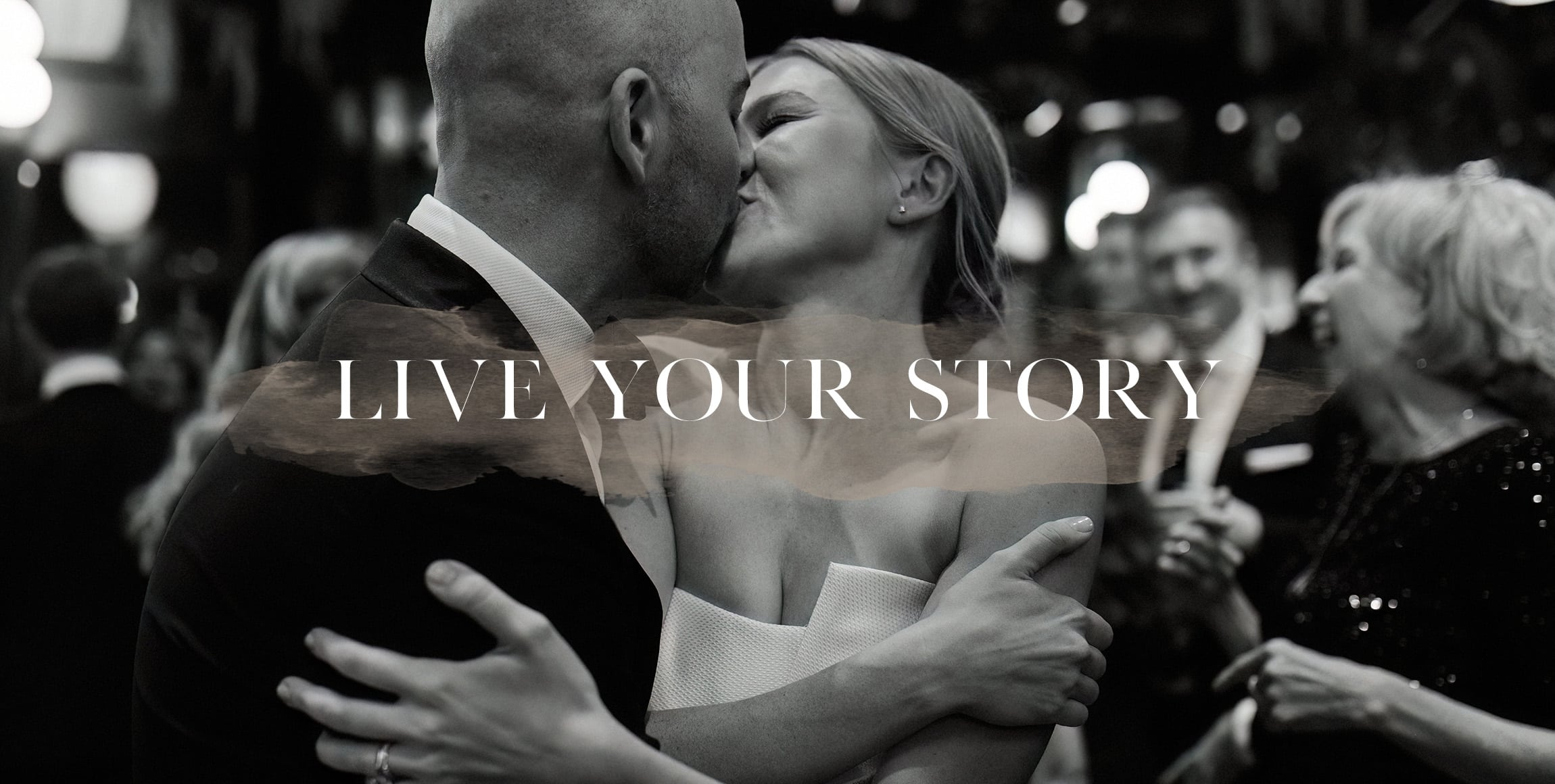 An image of a bride and groom embracing and kissing on the dance floor by Detroit Wedding Photographer, Heather Jowett.