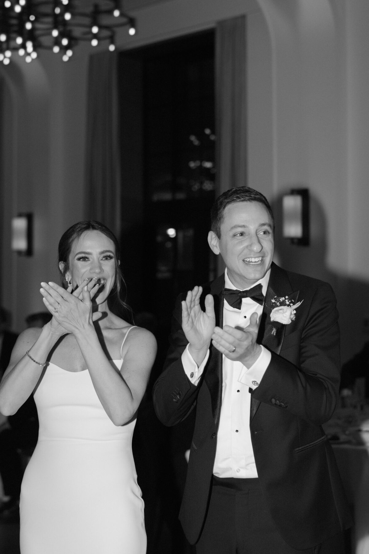 Couple clapping during their wedding reception.