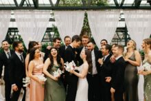 a wedding party wearing shades of peach and green at a Planterra Conservatory Wedding