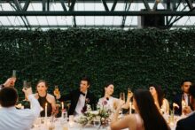 Bride and groom raising their glasses at their wedding at Planterra Conservatory photographed by wedding photographer Heather Jowett