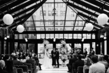 black and white photograph of a wedding ceremony in the birdy room