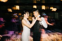 candid photo of bride and groom dancing with motion blur